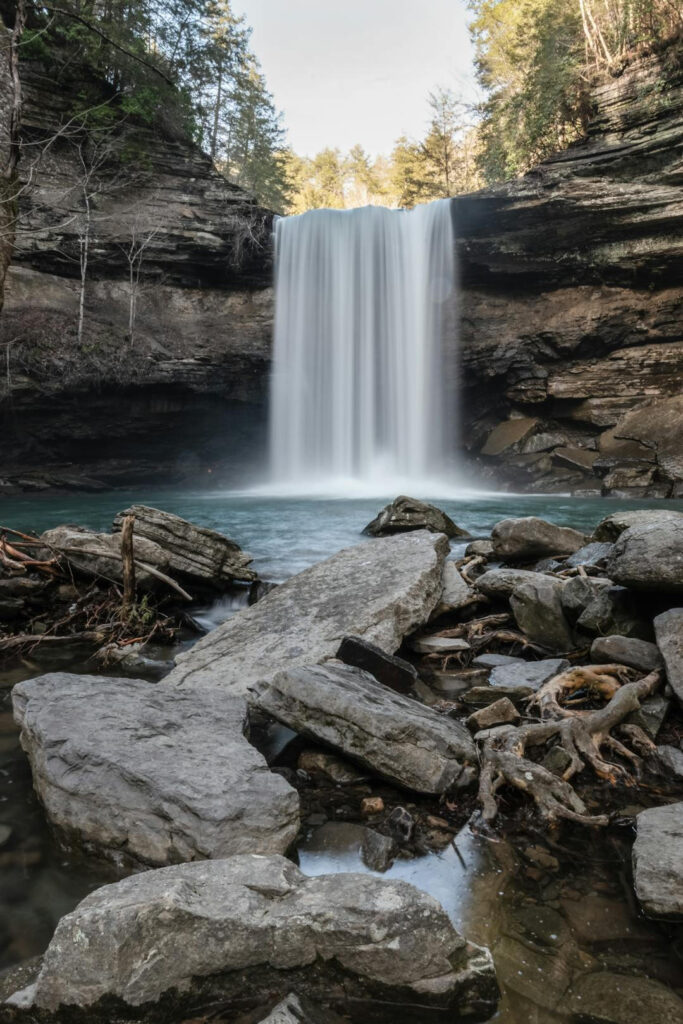 Greeter Falls drops into a clear blue pool on a crisp day.