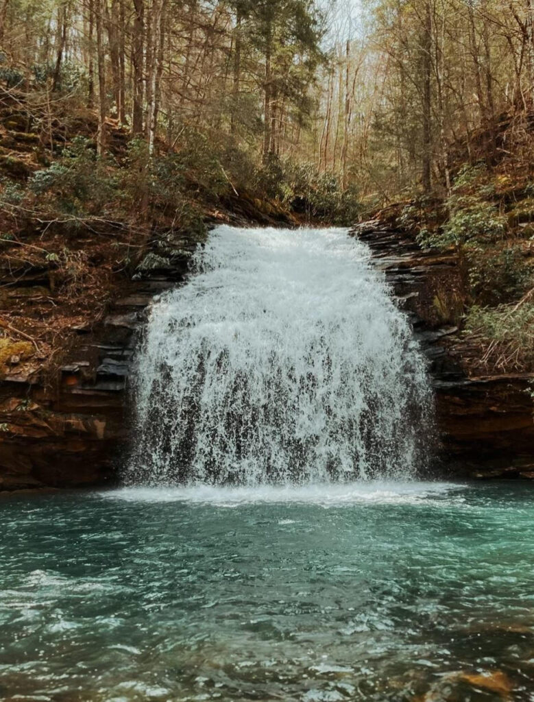 Stinging Fork Falls cascades into a turquoise mountain pool making it clear why it is one of the best waterfalls in Tennessee